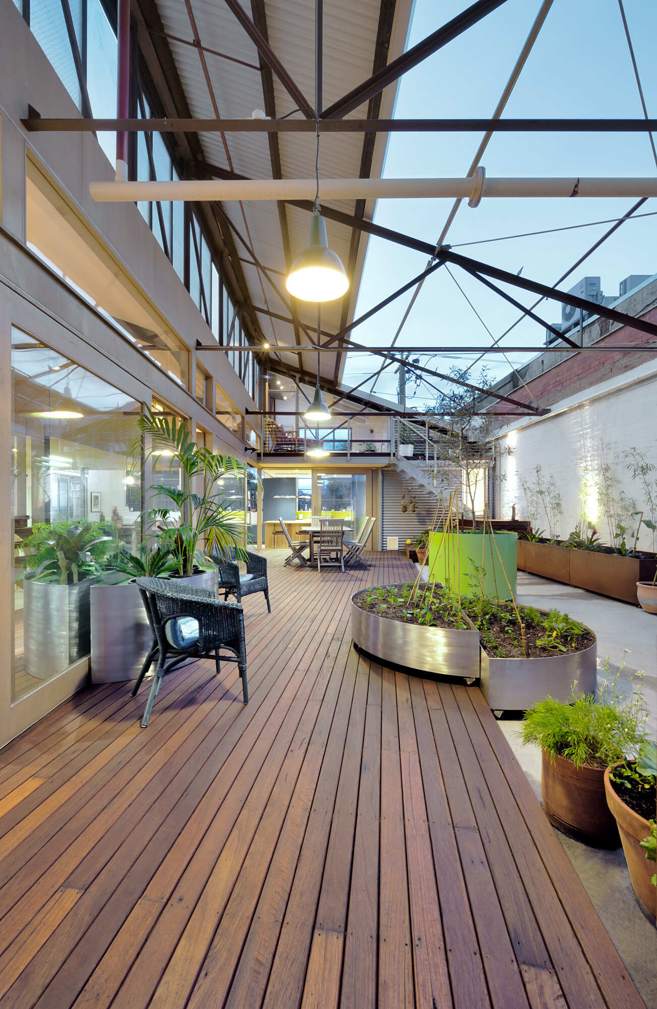 Sunlit courtyard and raised wood deck create a seamless connection between indoor and outdoor living in this converted Melbourne warehouse.