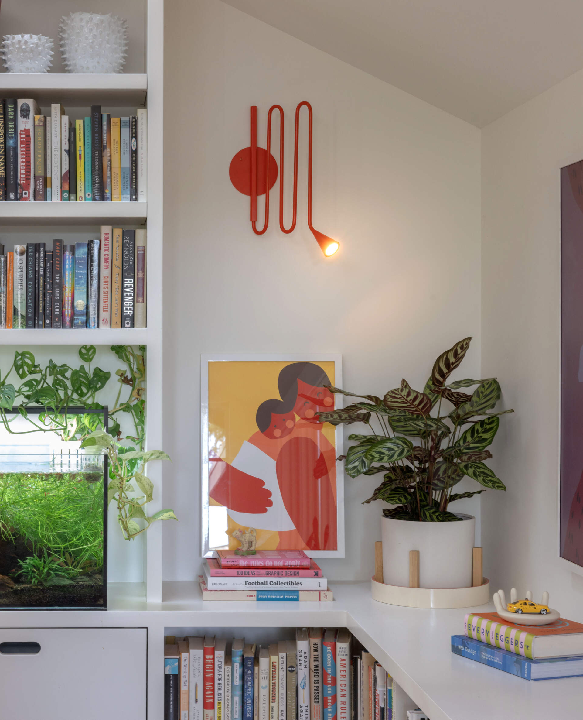 BEFORE - Open living and dining spaces now feature coral-painted steel beams and floor-to-ceiling bookshelves.