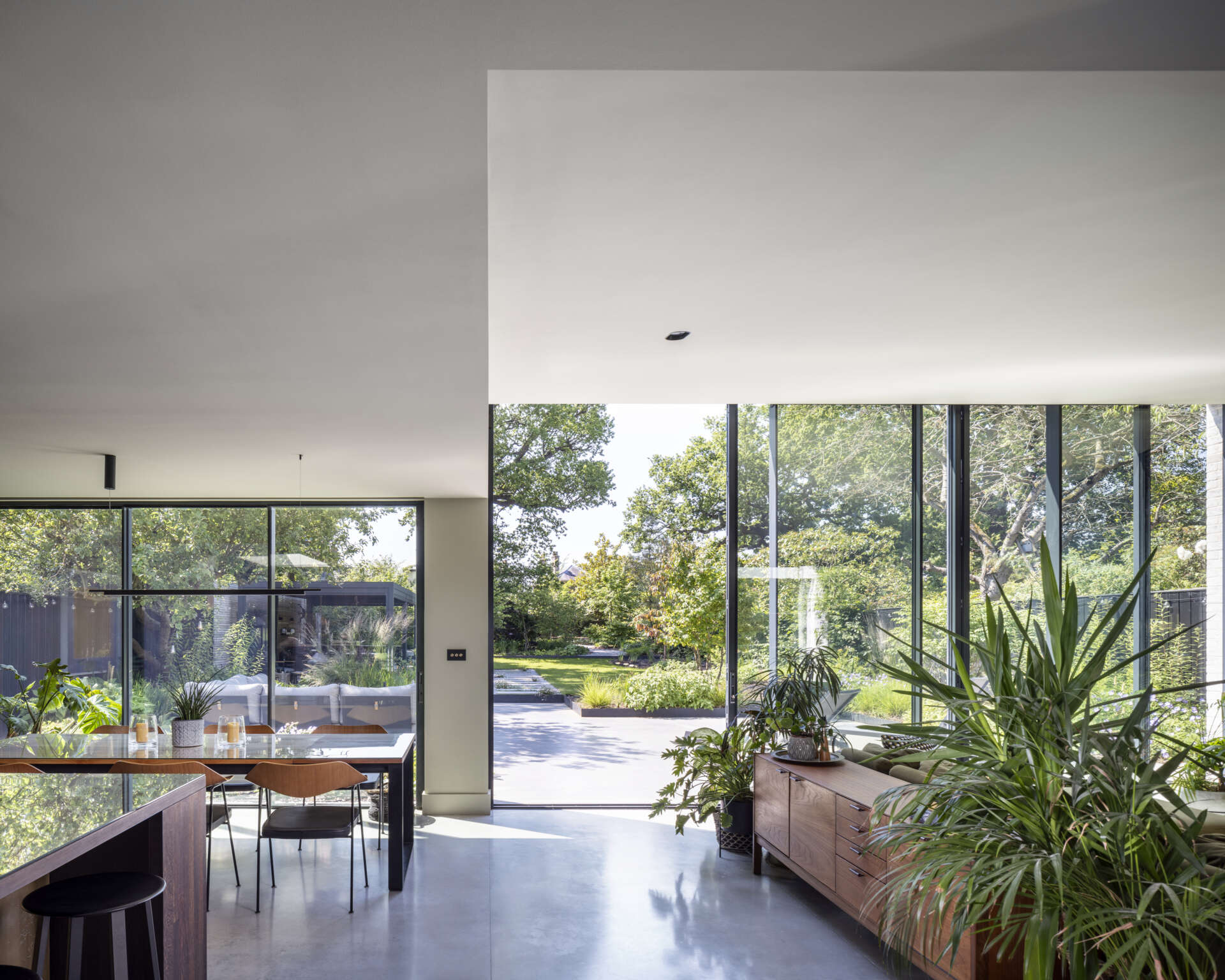 Sliding doors open the living room to the garden, creating an effortless indoor-outdoor connection.