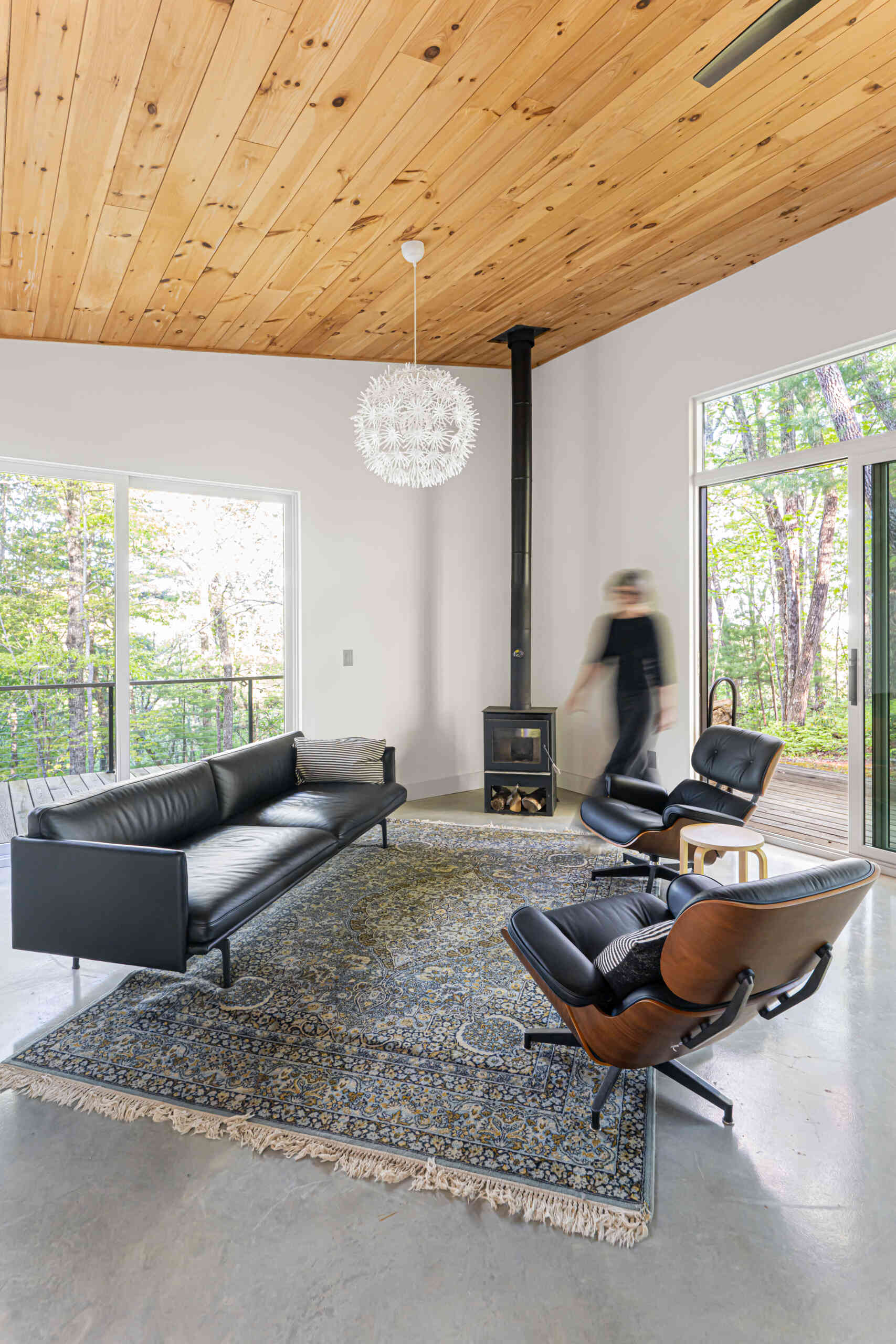 Open-plan living room with covered decks that frame mountain views, blending indoor comfort with outdoor scenery.