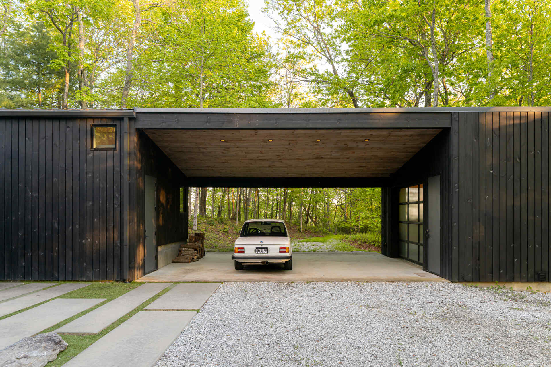 The garage doubles as a flexible space, serving as a carport, office, and a playful area for tinkering or projects. Positioned strategically along the logging road, it balances function and form, creating a practical yet inviting entry point to the property.