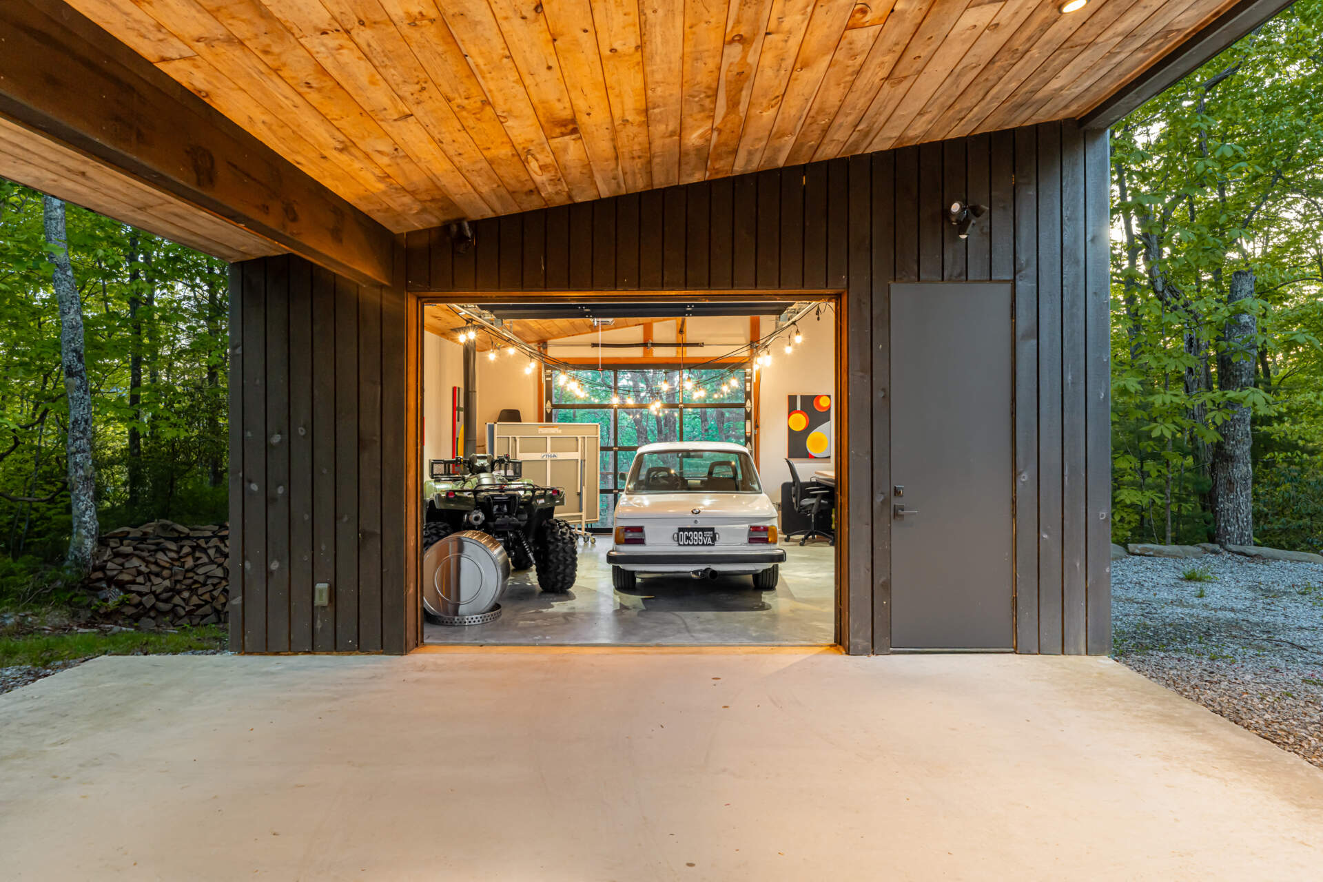 The garage doubles as a flexible space, serving as a carport, office, and a playful area for tinkering or projects. Positioned strategically along the logging road, it balances function and form, creating a practical yet inviting entry point to the property.