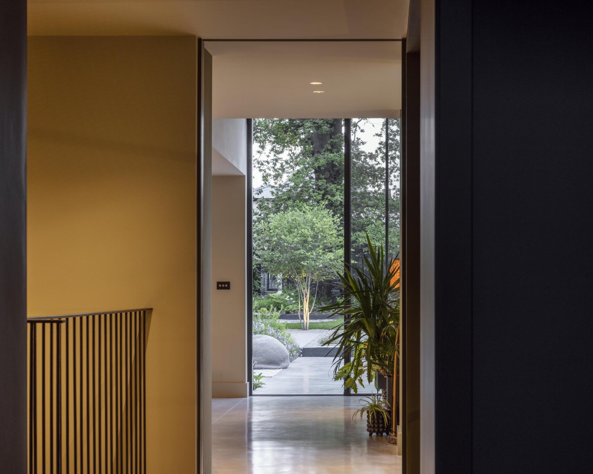The new staircase acts as a centerpiece, connecting all four levels with grace. It introduces vertical sightlines that carry the eye through the house, reinforcing the feeling of openness.