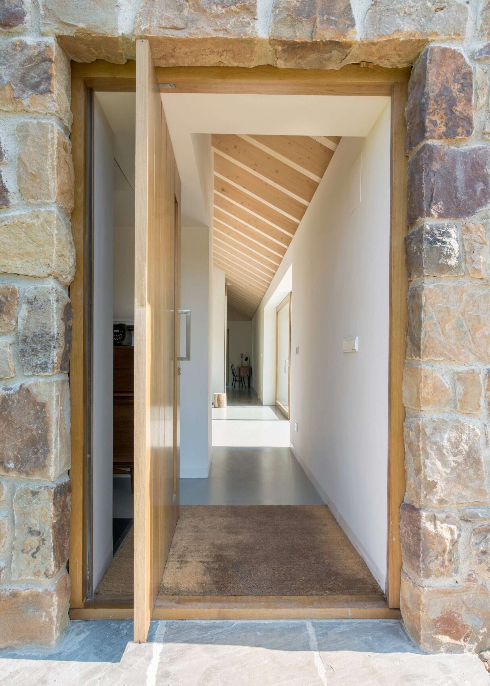 A pivoting wood door on a stone cottage.