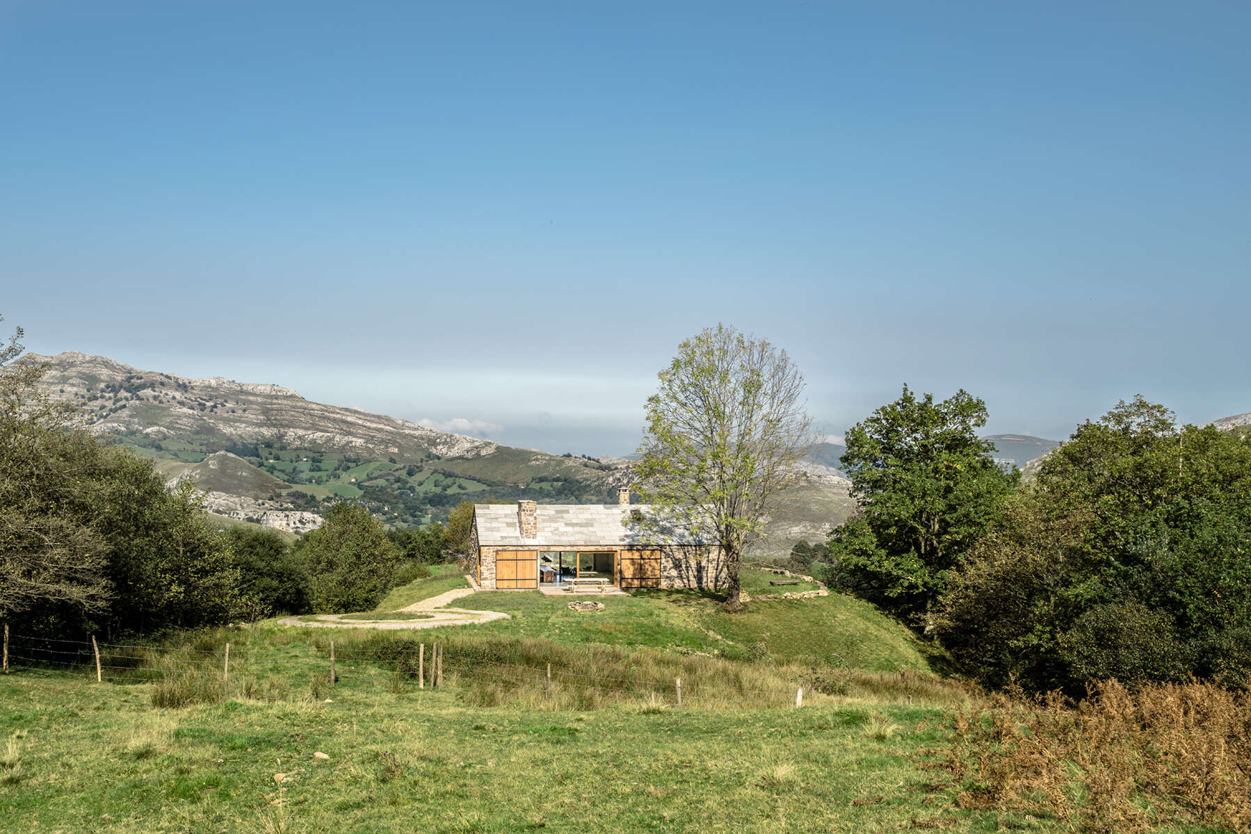 Spanish architect Laura Alvarez returns to her roots to design a serene mountain cottage inspired by childhood memories.
