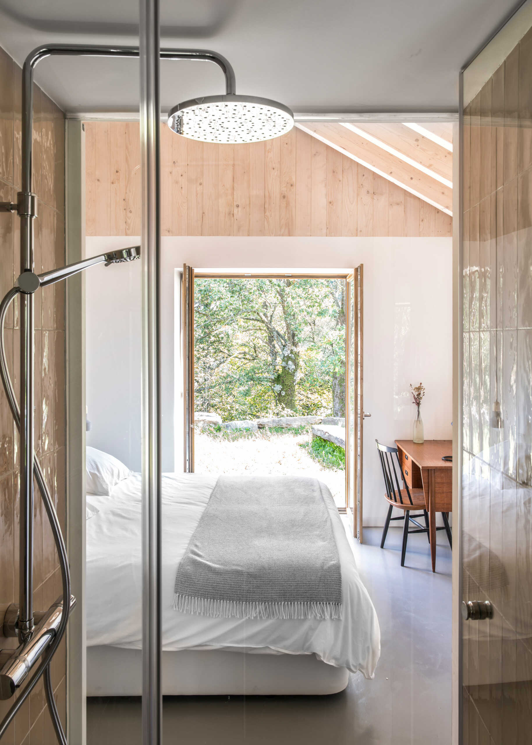 A modern yet minimal bedroom with a loft above the bathroom and closet.