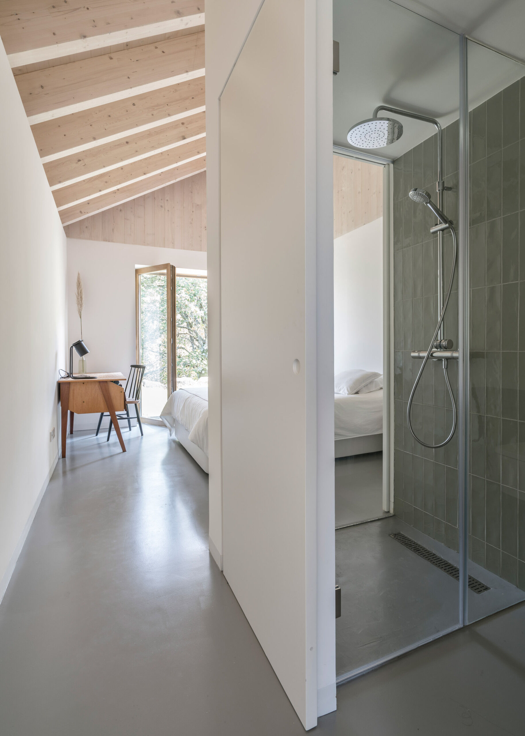 A modern yet minimal bedroom with a loft above the bathroom and closet.