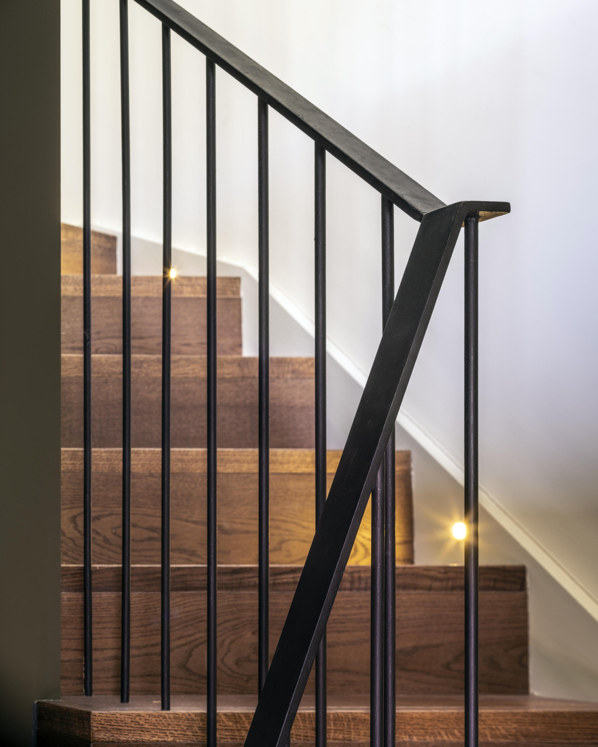 The new staircase acts as a centerpiece, connecting all four levels with grace. It introduces vertical sightlines that carry the eye through the house, reinforcing the feeling of openness.