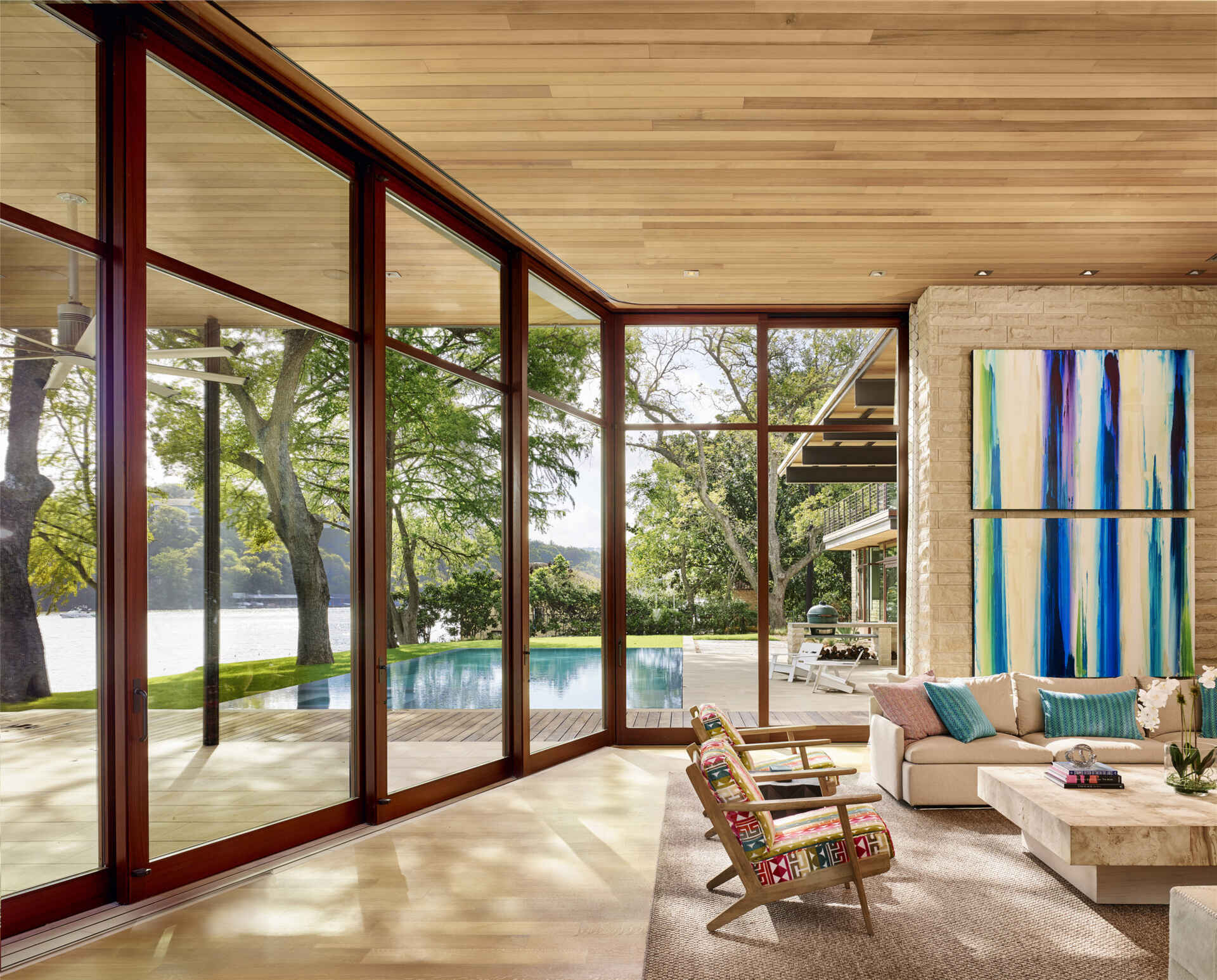 A bright artwork brings color and character to this relaxed living area, where sliding glass doors open to the pool and deck.