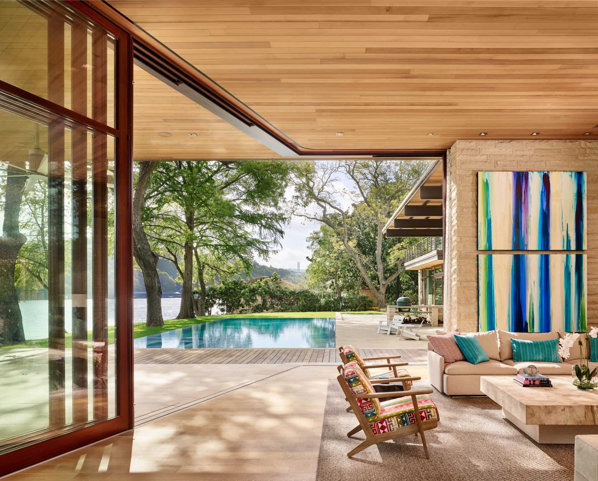 A bright artwork brings color and character to this relaxed living area, where sliding glass doors open to the pool and deck.