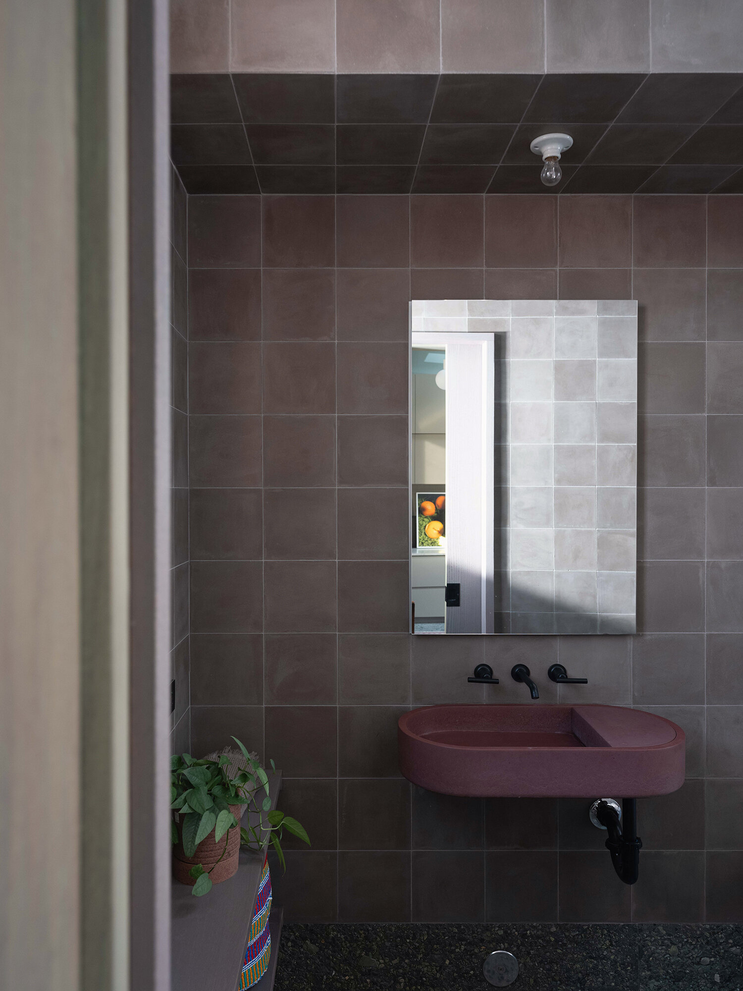 Natural stone, wood, and handmade tile come together in a small yet refined bathroom designed around light, texture, and simplicity.