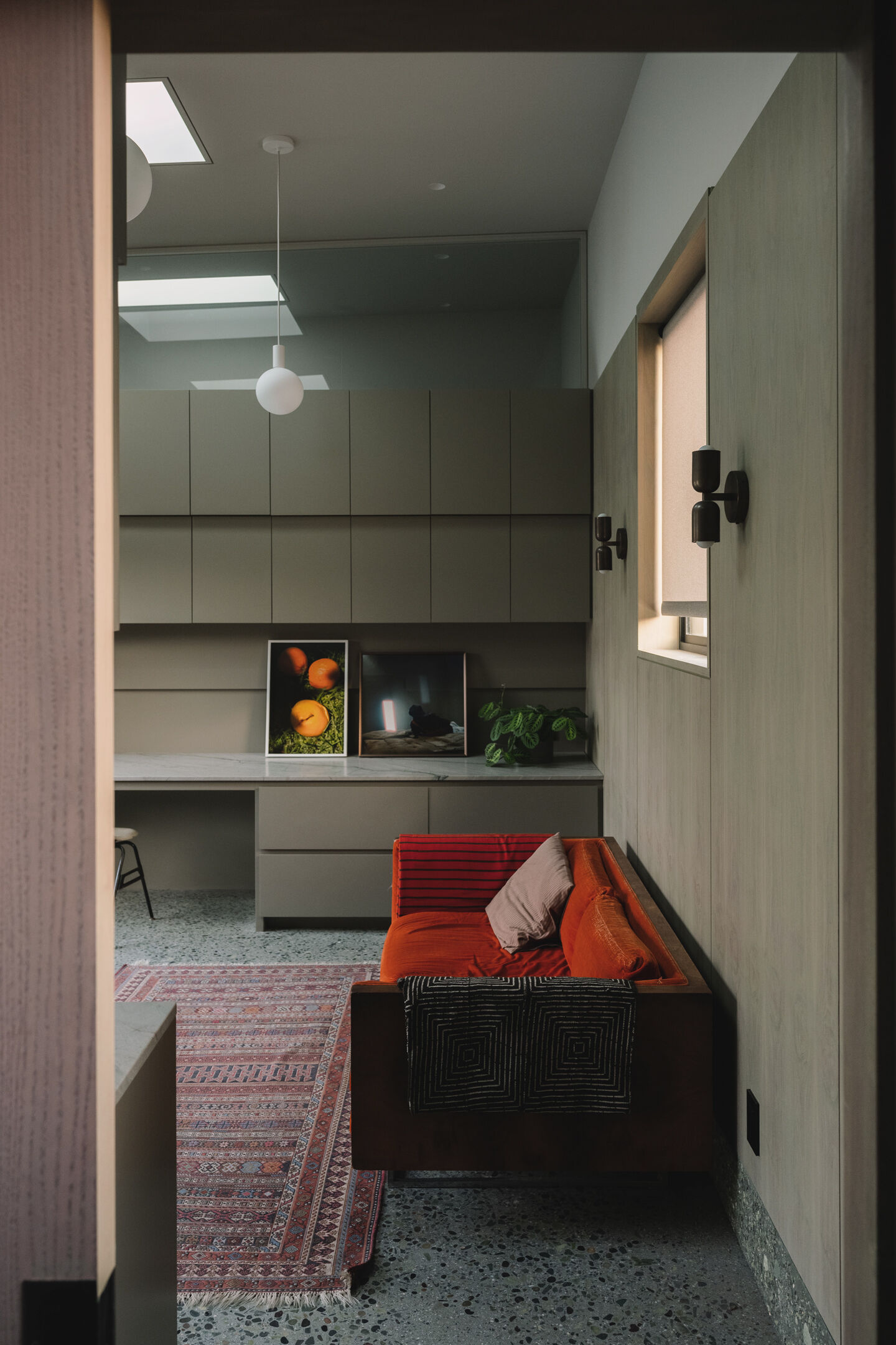 Walnut wall panels and handcrafted details define the living space, merging artistry and architecture in one quietly expressive room.