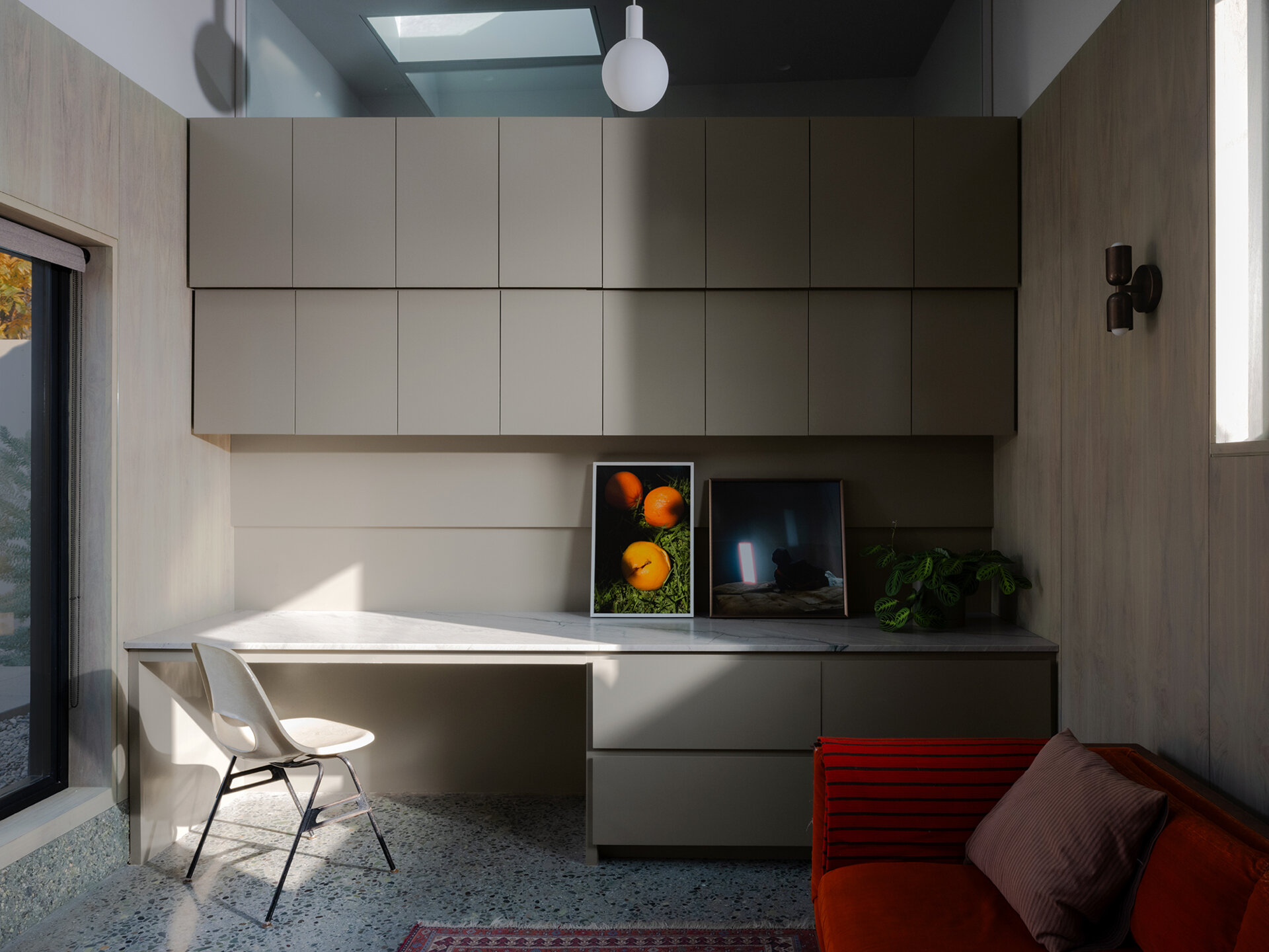 Walnut wall panels and handcrafted details define the living space, merging artistry and architecture in one quietly expressive room.