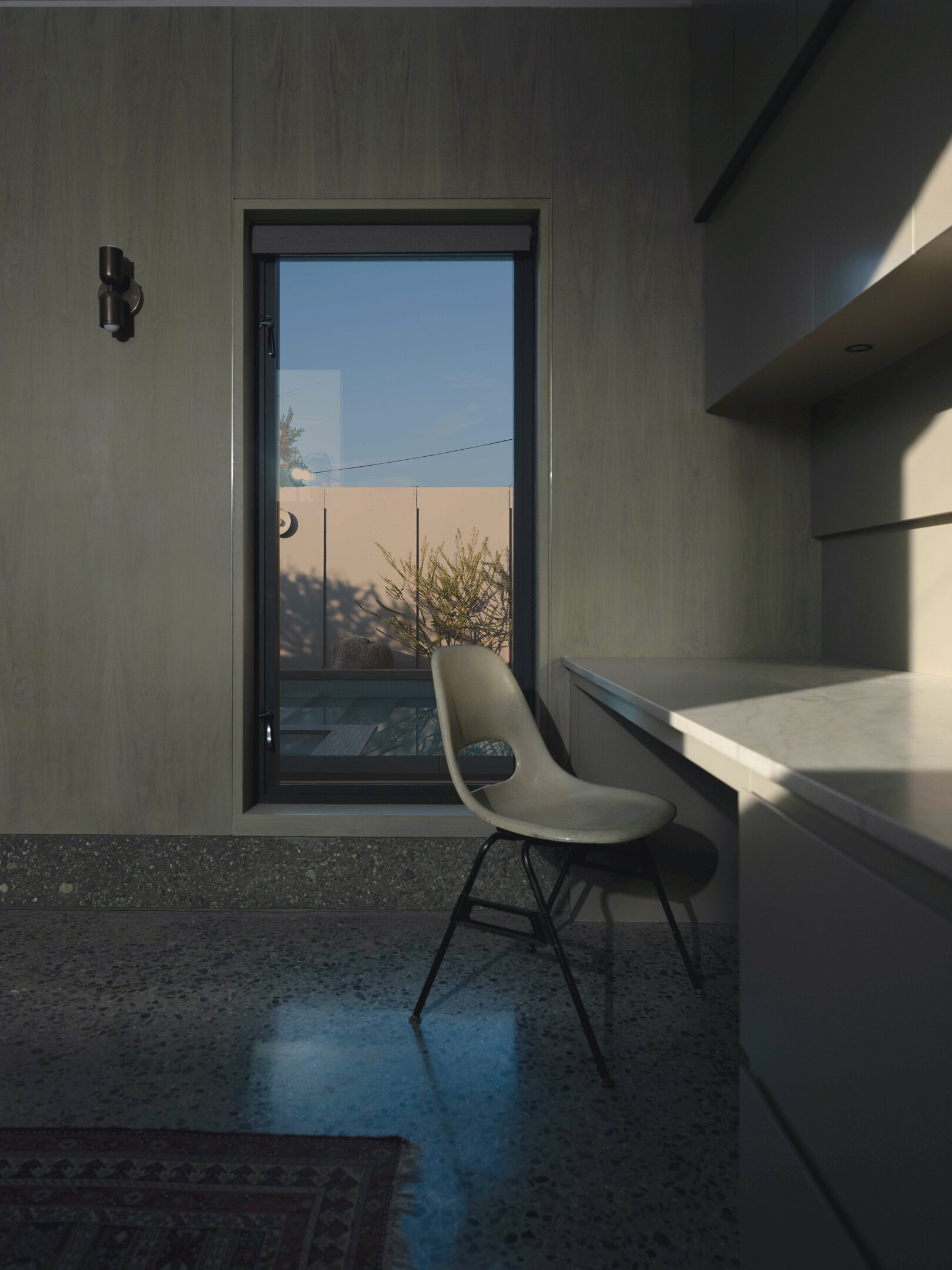 Walnut wall panels and handcrafted details define the living space, merging artistry and architecture in one quietly expressive room.
