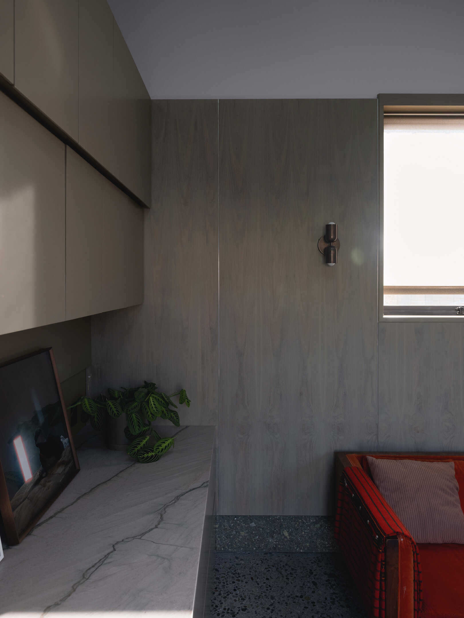 Walnut wall panels and handcrafted details define the living space, merging artistry and architecture in one quietly expressive room.