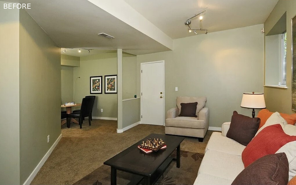 BEFORE - The updated basement is home to a custom built-in bench, and updated living room, and a small nook that doubles as a bedroom when the bed is revealed.