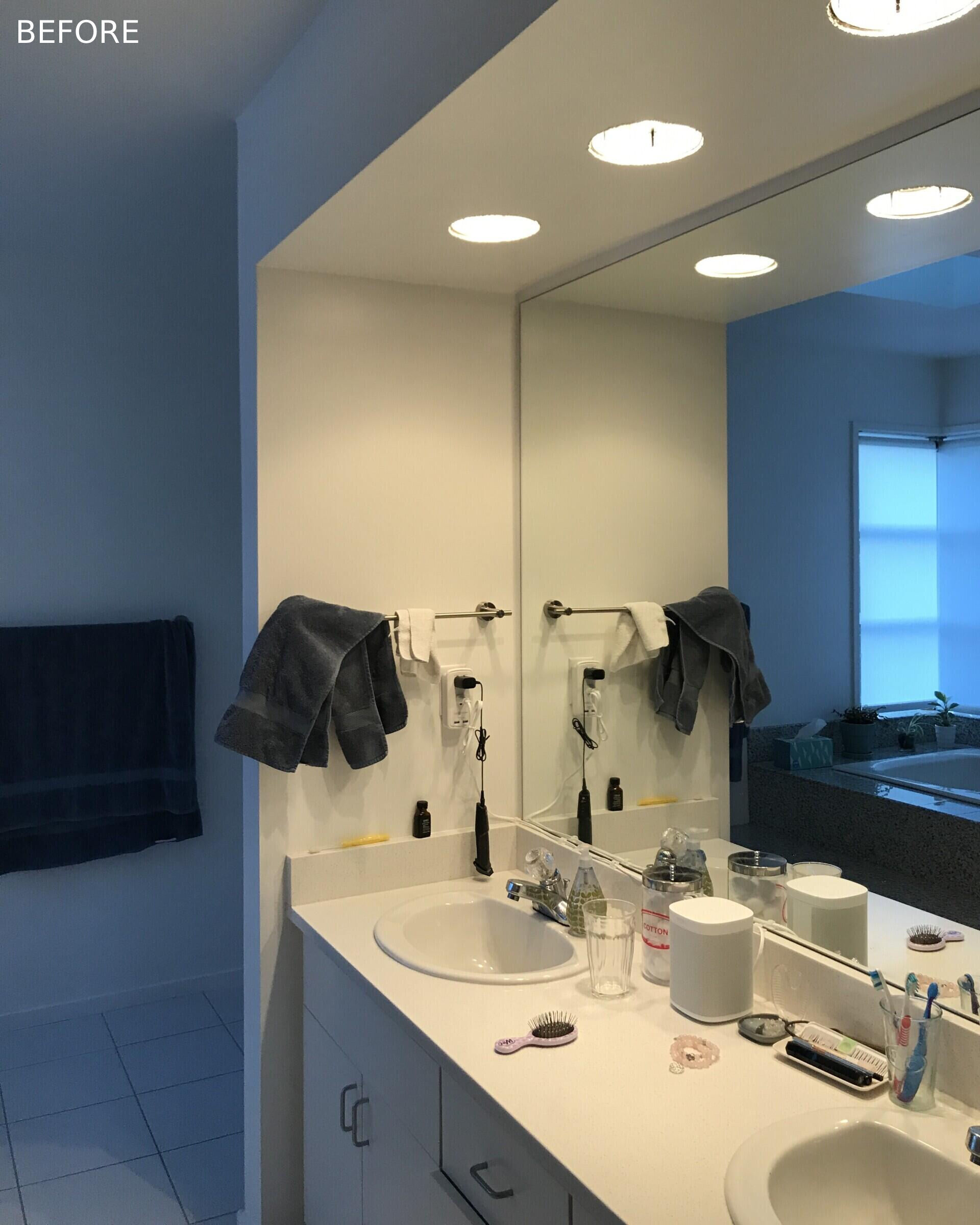 BEFORE - In the primary bath, Fireclay Hood River Gloss tile wraps the walls while Daltile Outlander Marine tile grounds the floor. Privacy glass, mirrors, and full height detailing emphasize height and brightness.