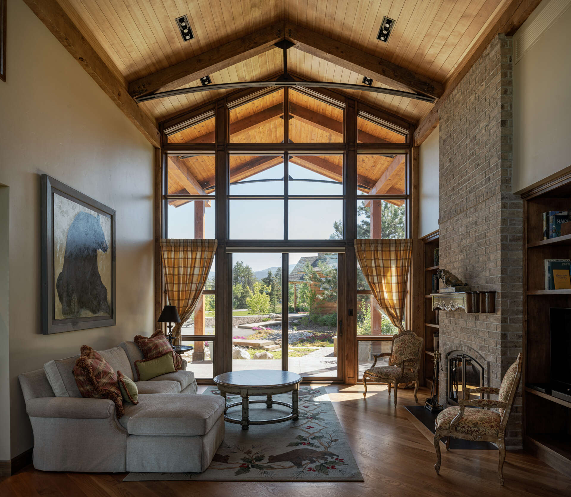 Sunlight floods the living, kitchen, and dining areas, while steel trusses, and personalized artwork add warmth and whimsy to a functional, comfortable mountain retreat.