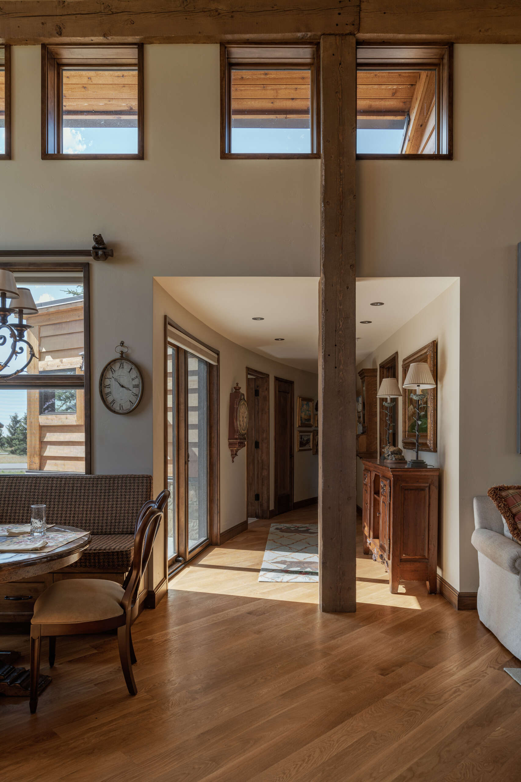 Sunlight floods the living, kitchen, and dining areas, while steel trusses, and personalized artwork add warmth and whimsy to a functional, comfortable mountain retreat.