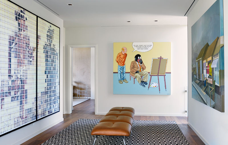 A hallway lined with art becomes a quiet gallery space that leads to the bedrooms.