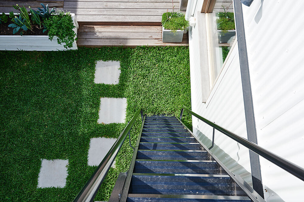 Solar panels and a green roof work together to reduce energy use and create a more efficient, insulated home.
