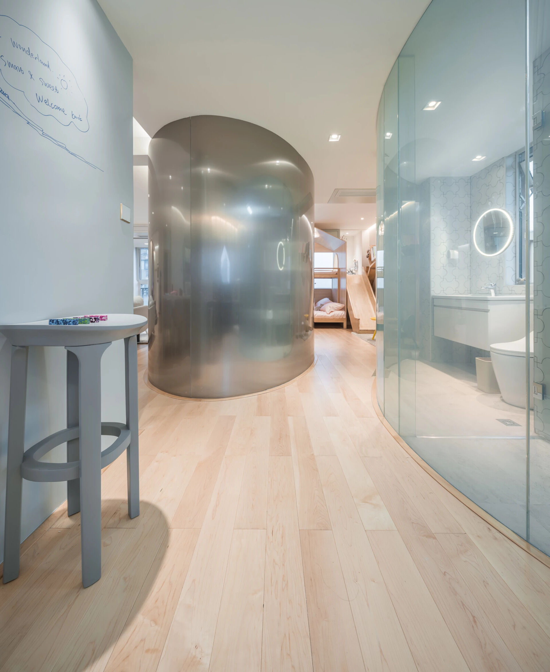 A Shanghai apartment that breaks down walls to bring a family closer together, with light, curves, and playful design touches.