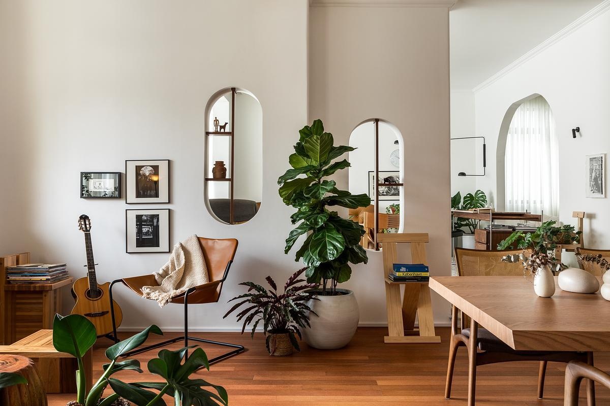 Lina Apartment by Alencar preserves its original 1980s arches and character while introducing Brazilian modernist furniture, flexible layouts, and three distinct living areas in a thoughtful renovation.