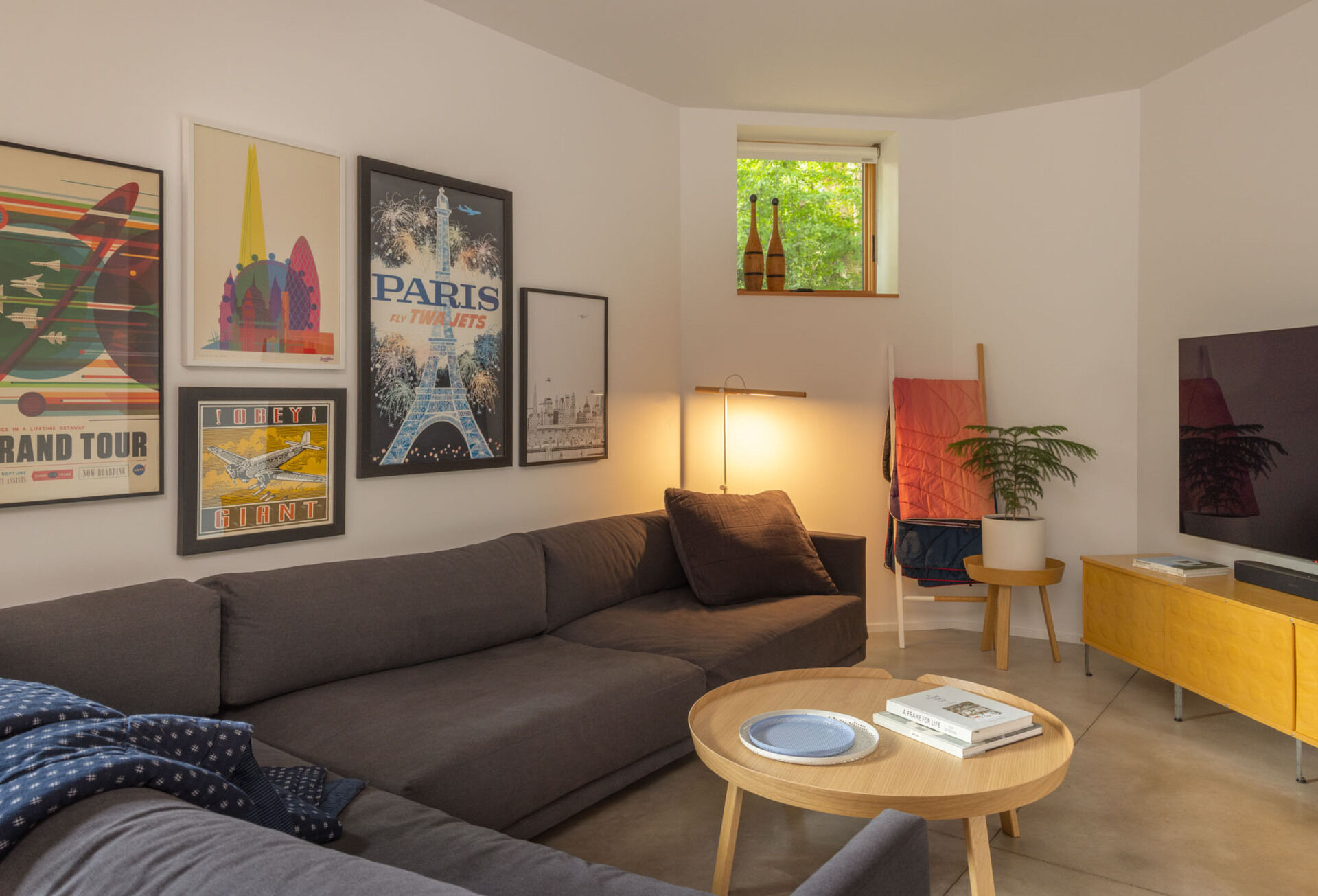 The updated basement is home to a custom built-in bench, and updated living room, and a small nook that doubles as a bedroom when the bed is revealed.