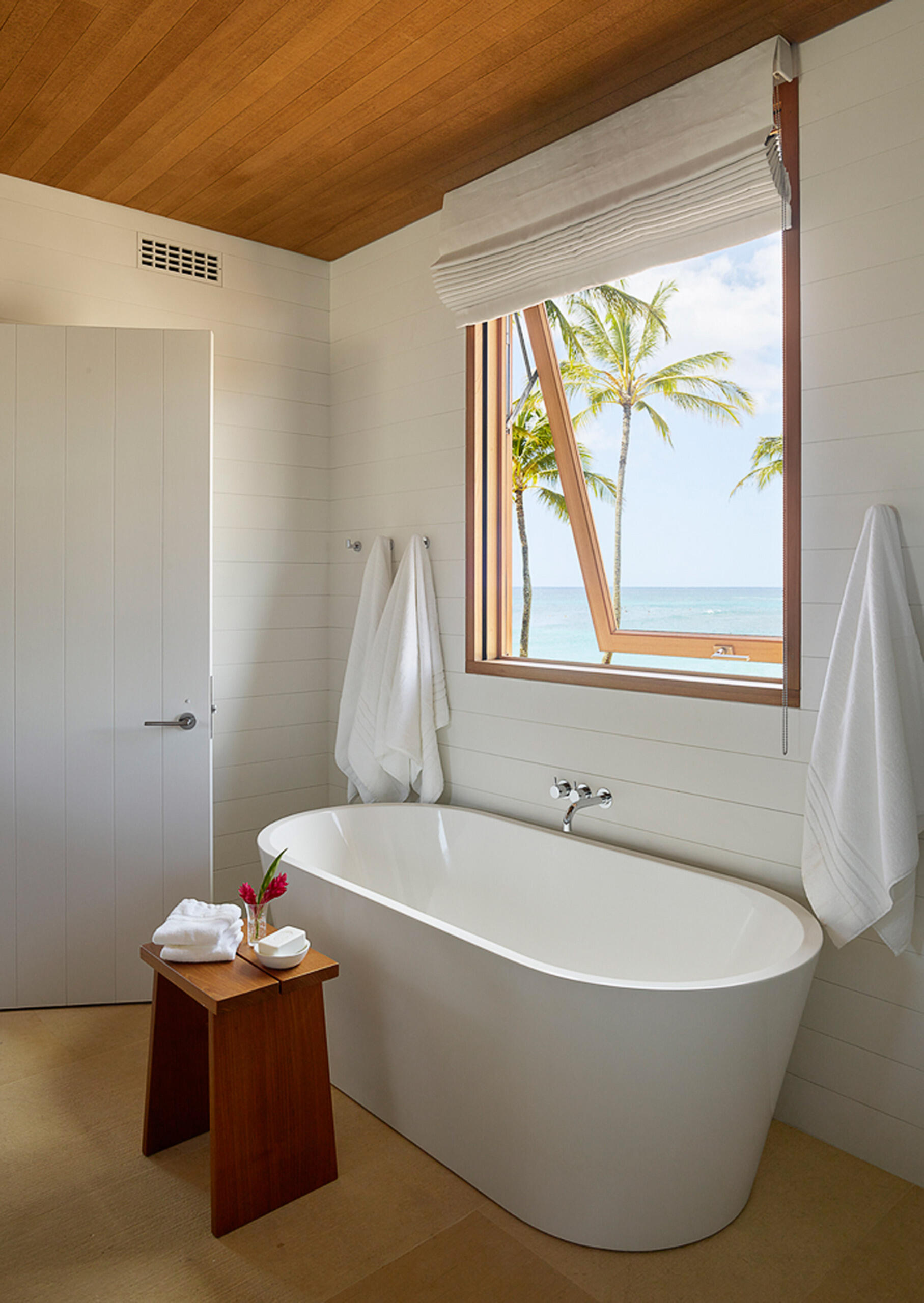 Spa-like bathrooms with ocean views and natural finishes define this Kauai home’s tranquil vibe.