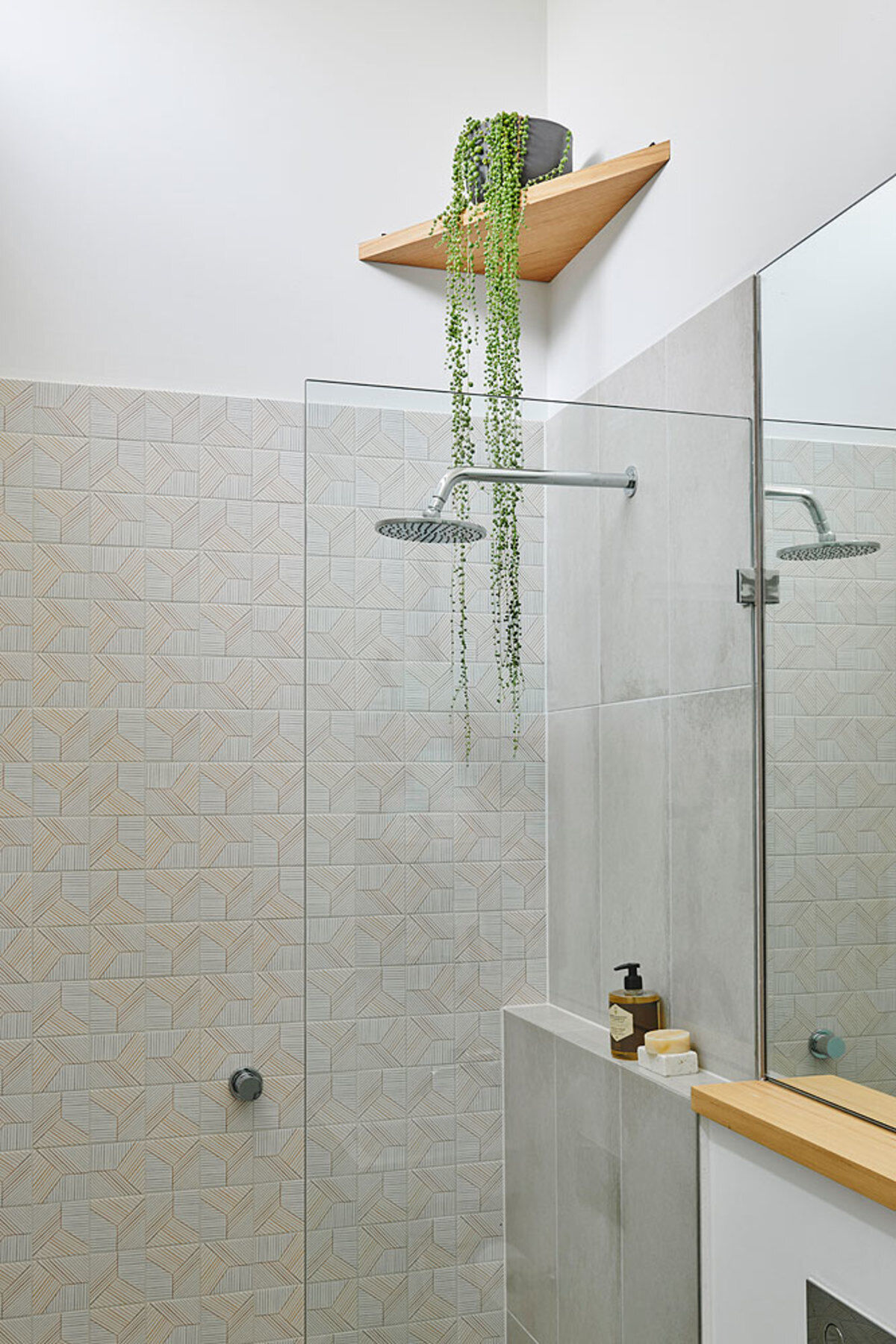 A refreshed bathroom with a freestanding bathtub, timber accents and plants for a natural and soothing look.