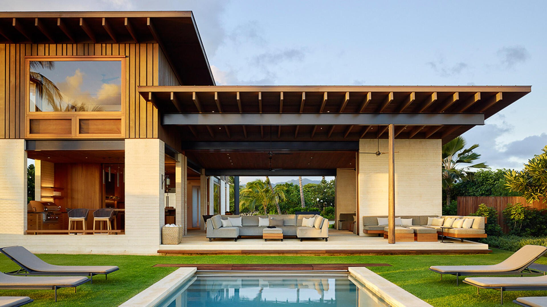 A seamless indoor-outdoor flow defines this Hawaiian home, complete with poolside lounge and outdoor kitchen.