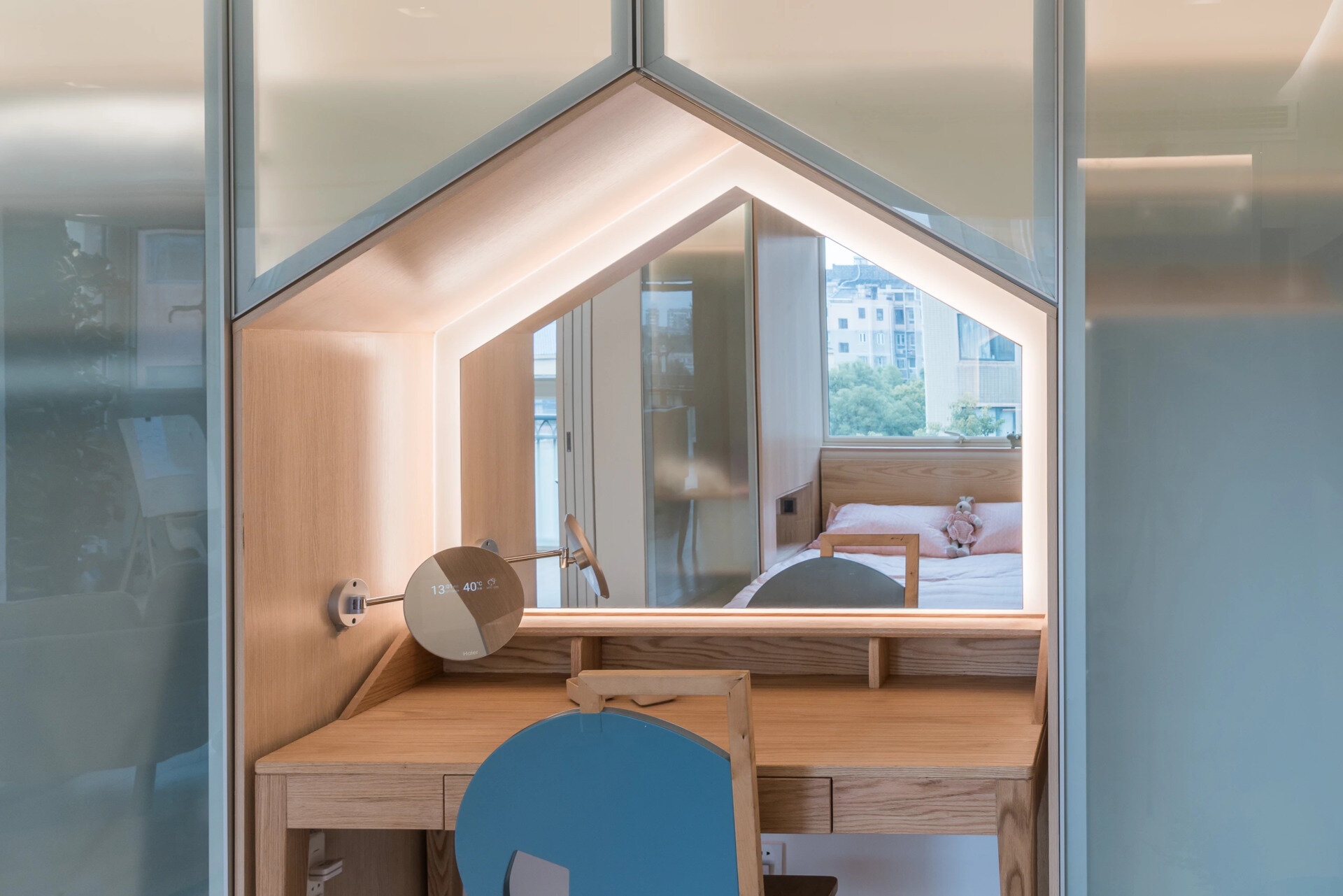 A serene pearl white bedroom with built-in storage and a softly glowing vanity.