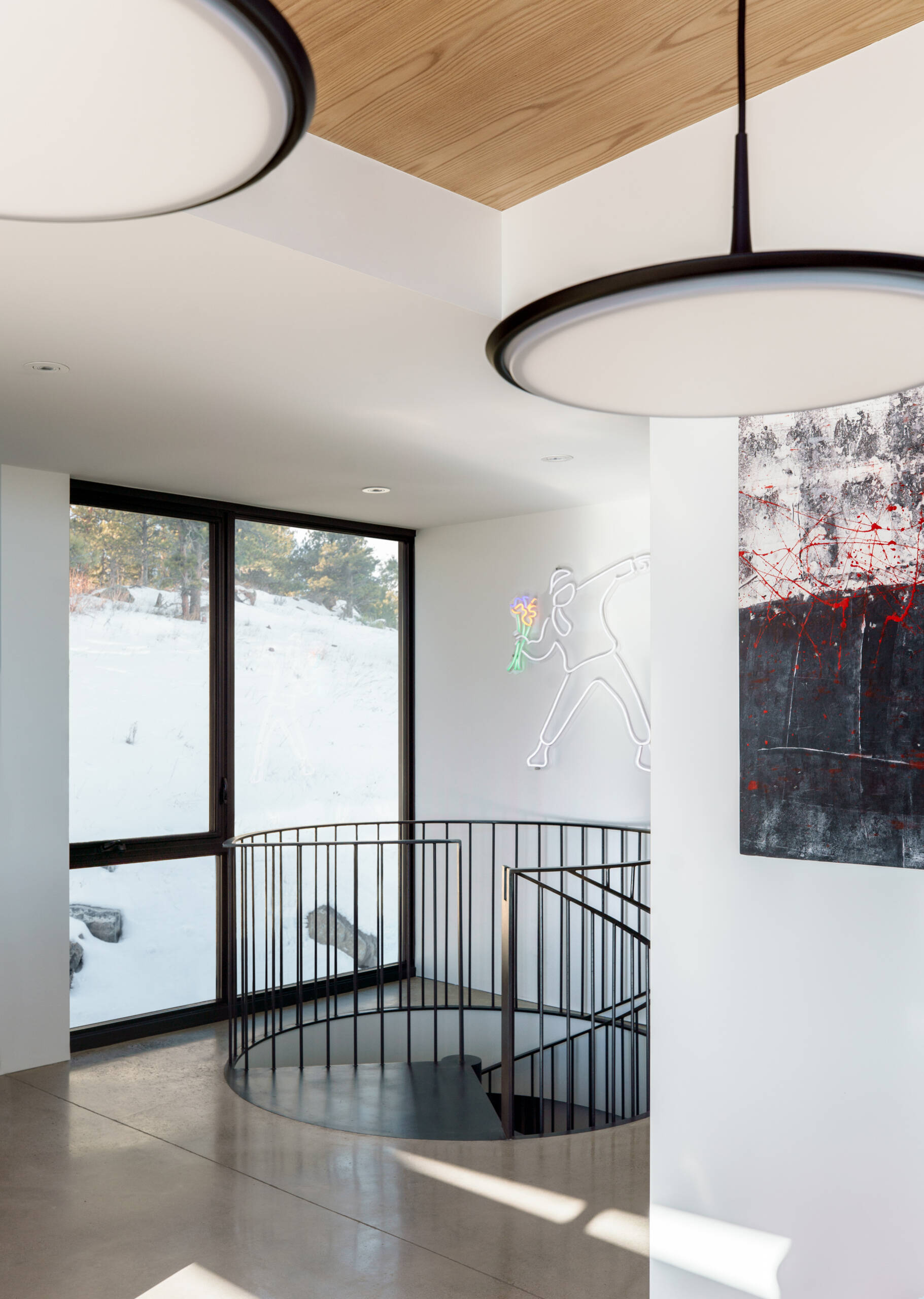 A custom steel spiral staircase saves space while adding a sculptural moment between levels.