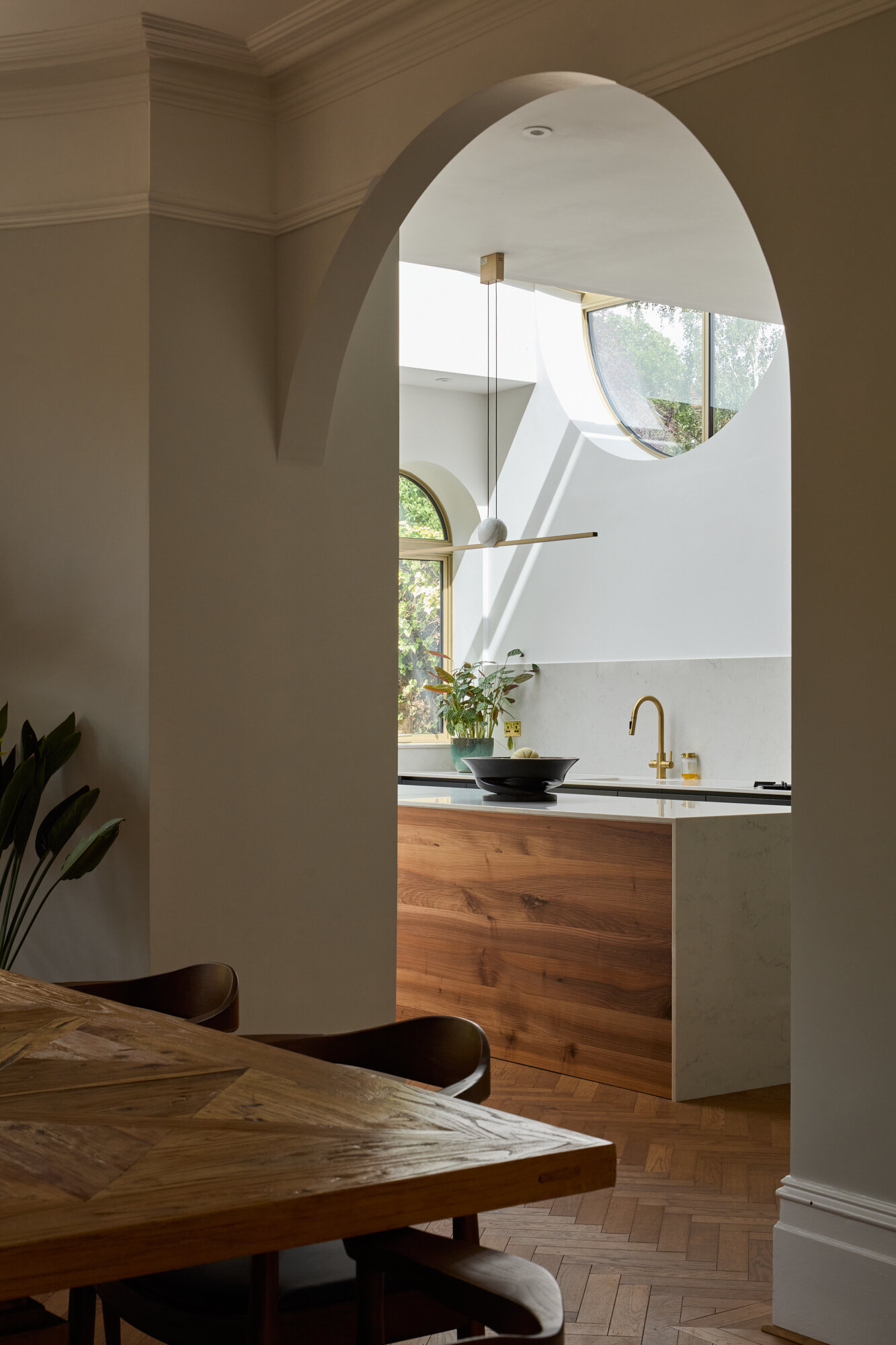 A archway connects this dining room to the new kitchen.