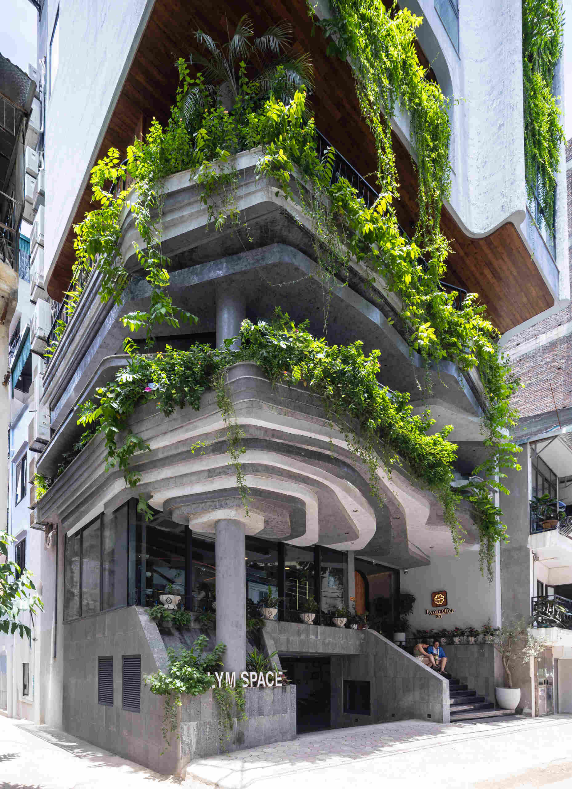 A serene, story-driven building in Hanoi that blends a bold vertical core with soft greenery, natural light, and gentle architectural rhythms to express resilience and quiet elegance in the city.