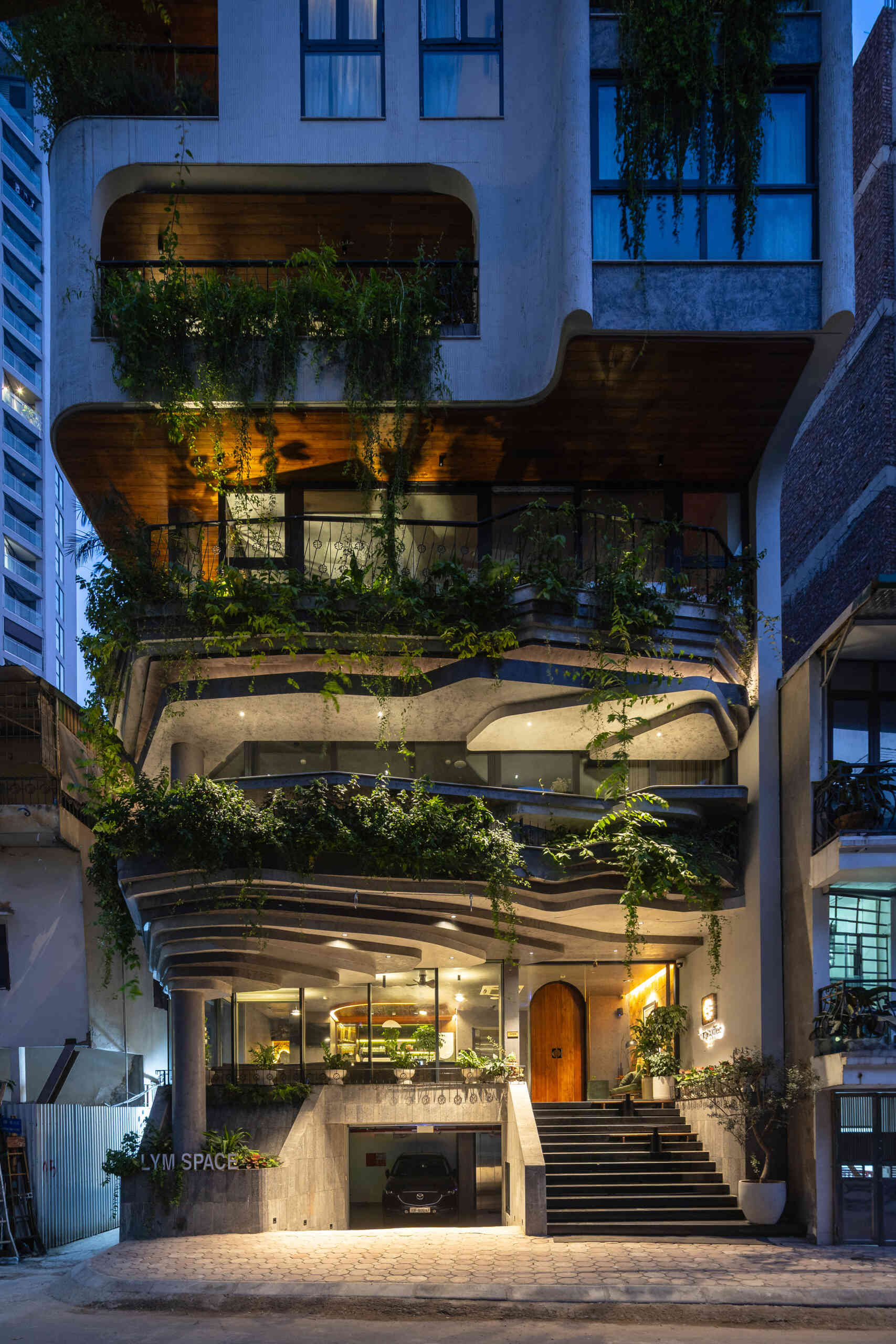 A serene, story-driven building in Hanoi that blends a bold vertical core with soft greenery, natural light, and gentle architectural rhythms to express resilience and quiet elegance in the city.