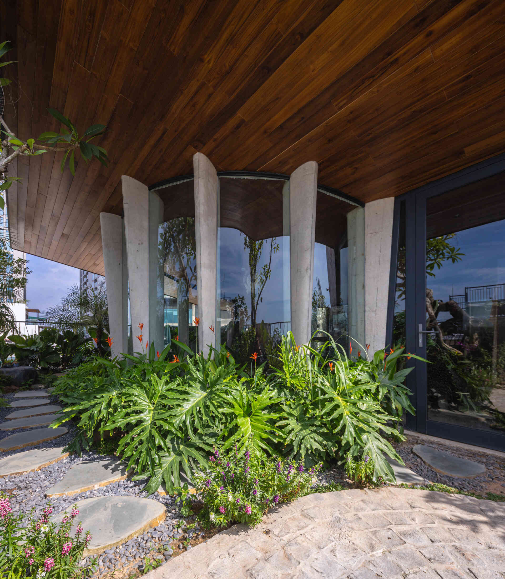 A serene, story-driven building in Hanoi that blends a bold vertical core with soft greenery, natural light, and gentle architectural rhythms to express resilience and quiet elegance in the city.