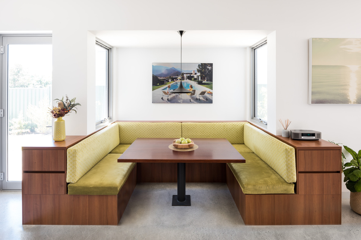 A custom diner style breakfast booth opposite the kitchen that acts as a cosy daily hub for the whole family.