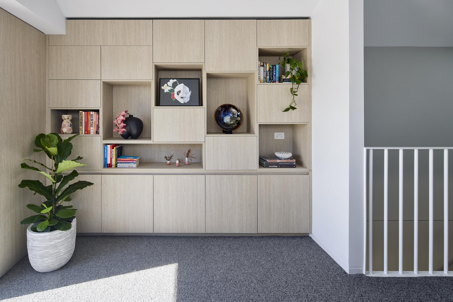 At the top of the stairs, there's a study zone and built in storage to support day to day family life, while a rooftop deck provides outdoor space.