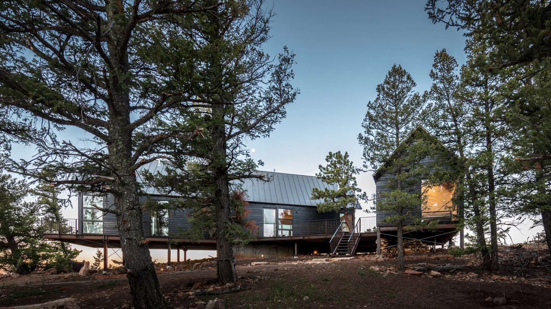 Dark stained cedar siding, gabled roofs, and expansive glass give these cabins a rustic yet refined style rooted in Colorado tradition.