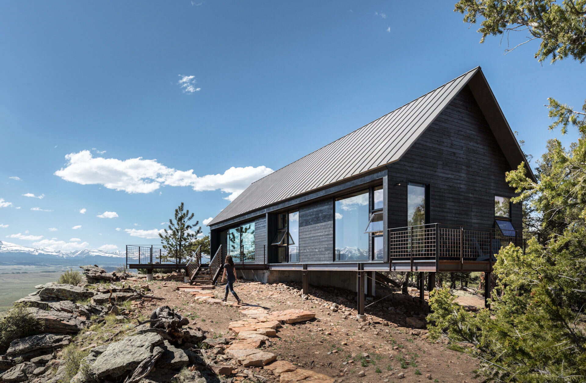 Dark stained cedar siding, gabled roofs, and expansive glass give these cabins a rustic yet refined style rooted in Colorado tradition.