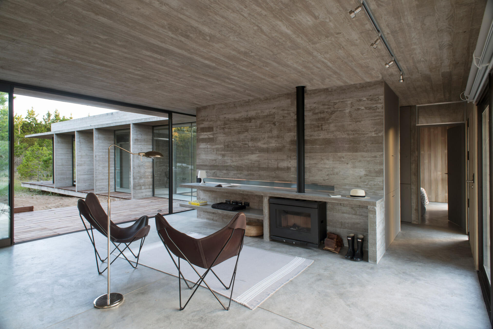 Board formed concrete walls and ceilings create a striking interior softened by natural light and full height windows.