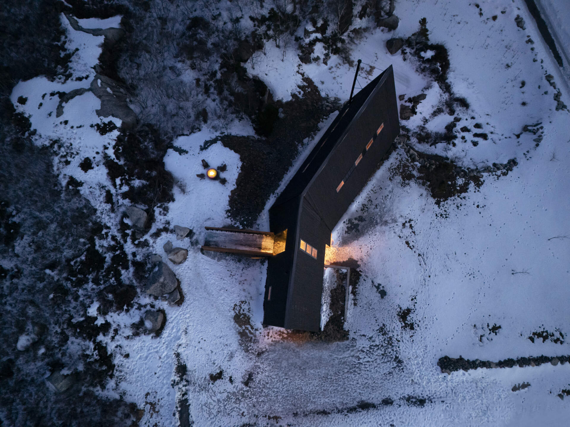 This B Frame cottage rises from bedrock with warm white oak interiors and polished concrete floors.
