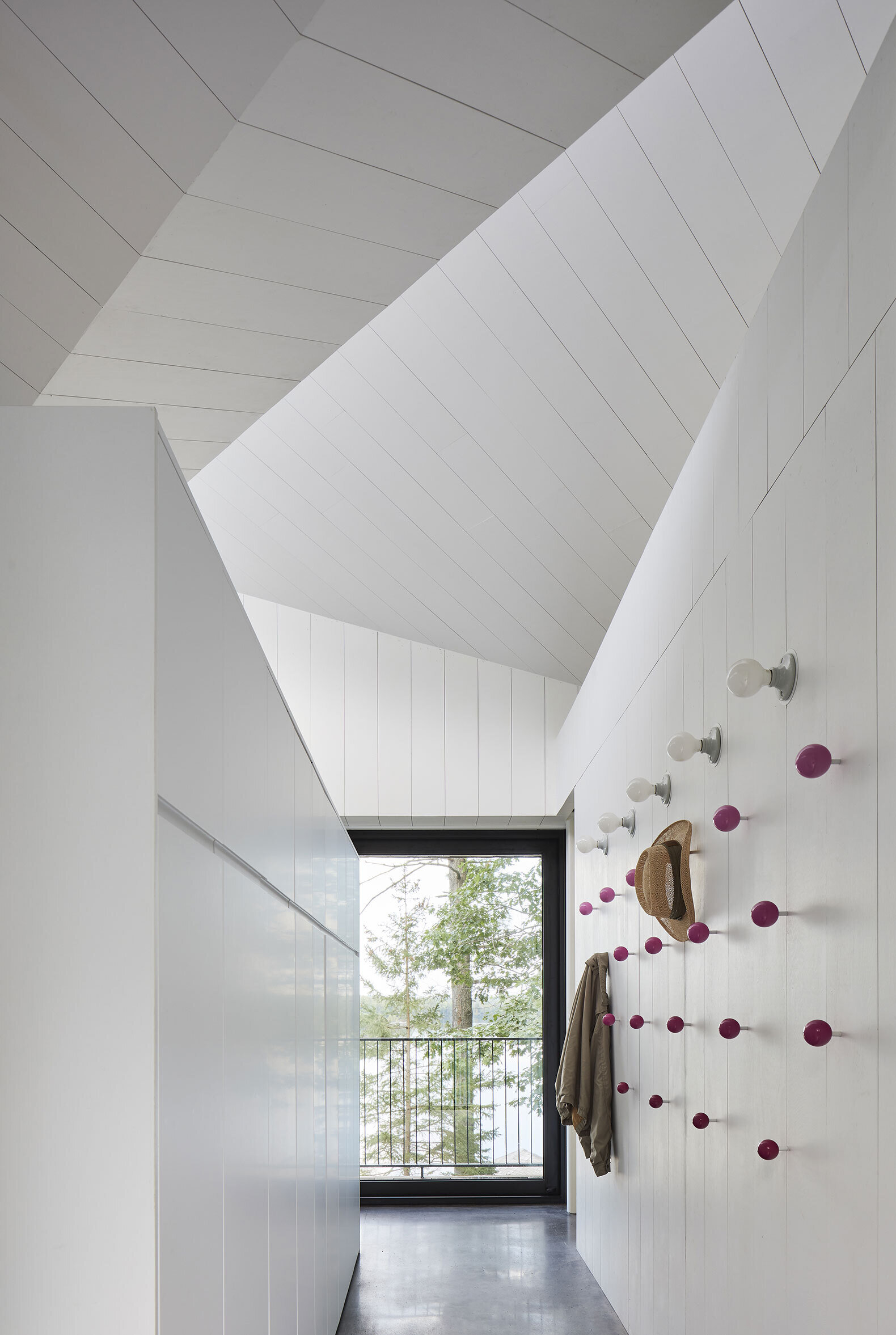 Unexpected color brings joy to this Canadian home, from pink coat hooks in the hallway to a cheerful yellow bathroom that lights up the all-white interior.