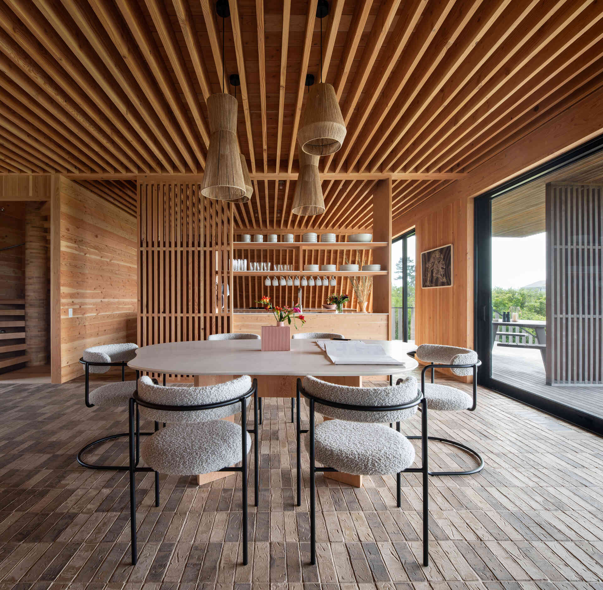 A minimalist dining area designed for togetherness, framed in solid wood and clay tiles that honor craftsmanship and simplicity.