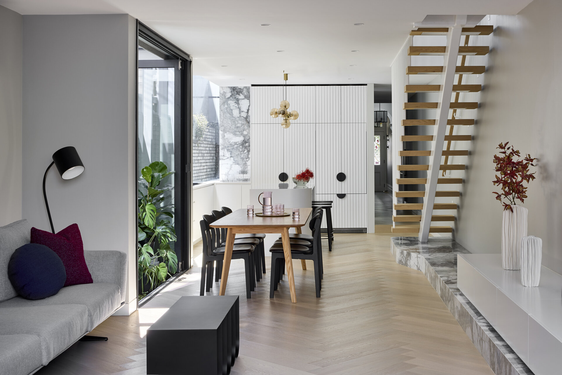 The dining area sits within the open plan arrangement, sharing the home’s light filled flow. Its proximity to the terrace helps the space feel larger than its footprint.