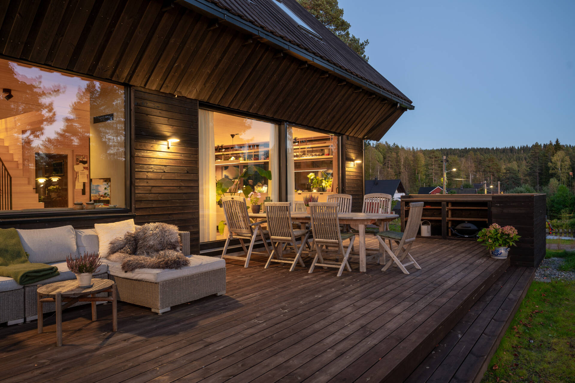 The deck sits gently on the sloping terrain, creating an outdoor area that feels part of the home. Residents can enjoy morning coffee or simply watch the seasons change from this sheltered, natural spot.