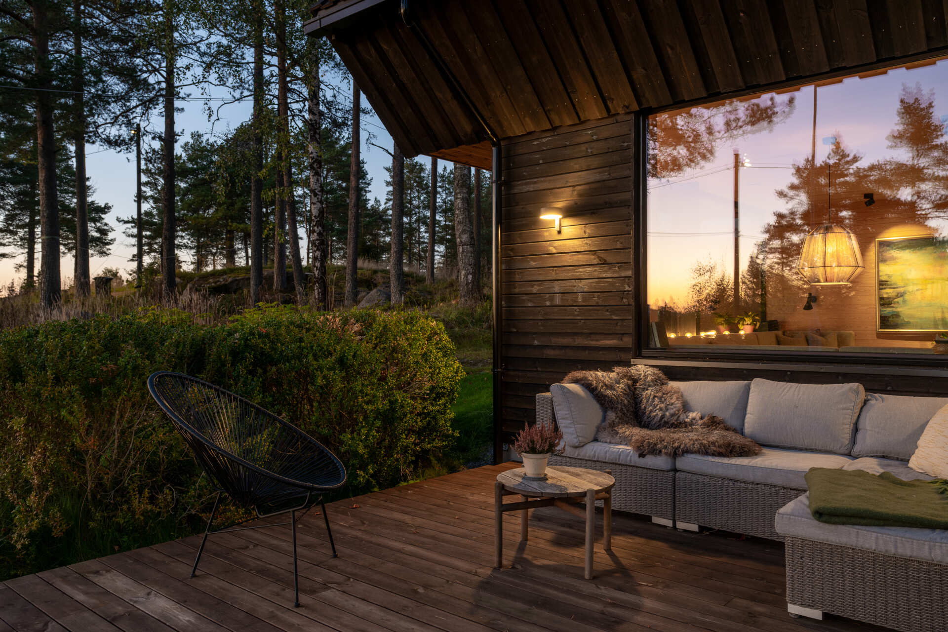 The deck sits gently on the sloping terrain, creating an outdoor area that feels part of the home. Residents can enjoy morning coffee or simply watch the seasons change from this sheltered, natural spot.
