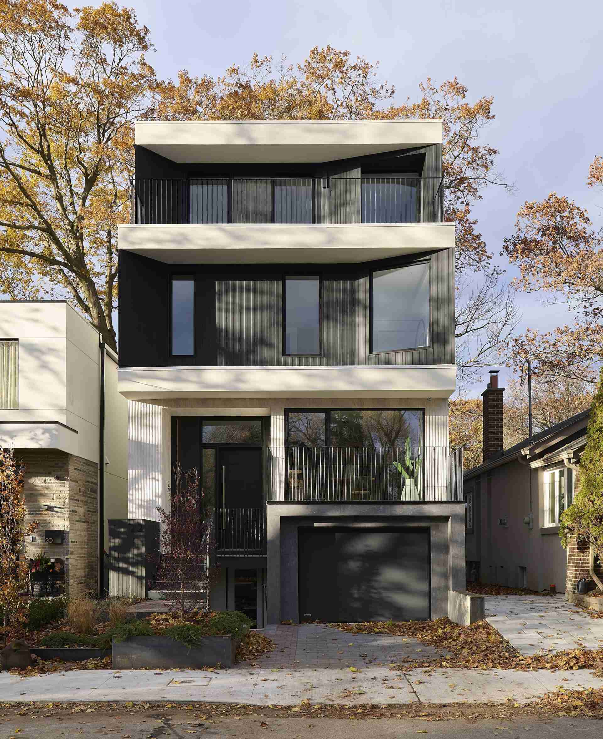 A modern home with a palette of fine stucco, black stained cedar, and composite stone carries into the interior through oak flooring, slim brick tile, and softly muted millwork.