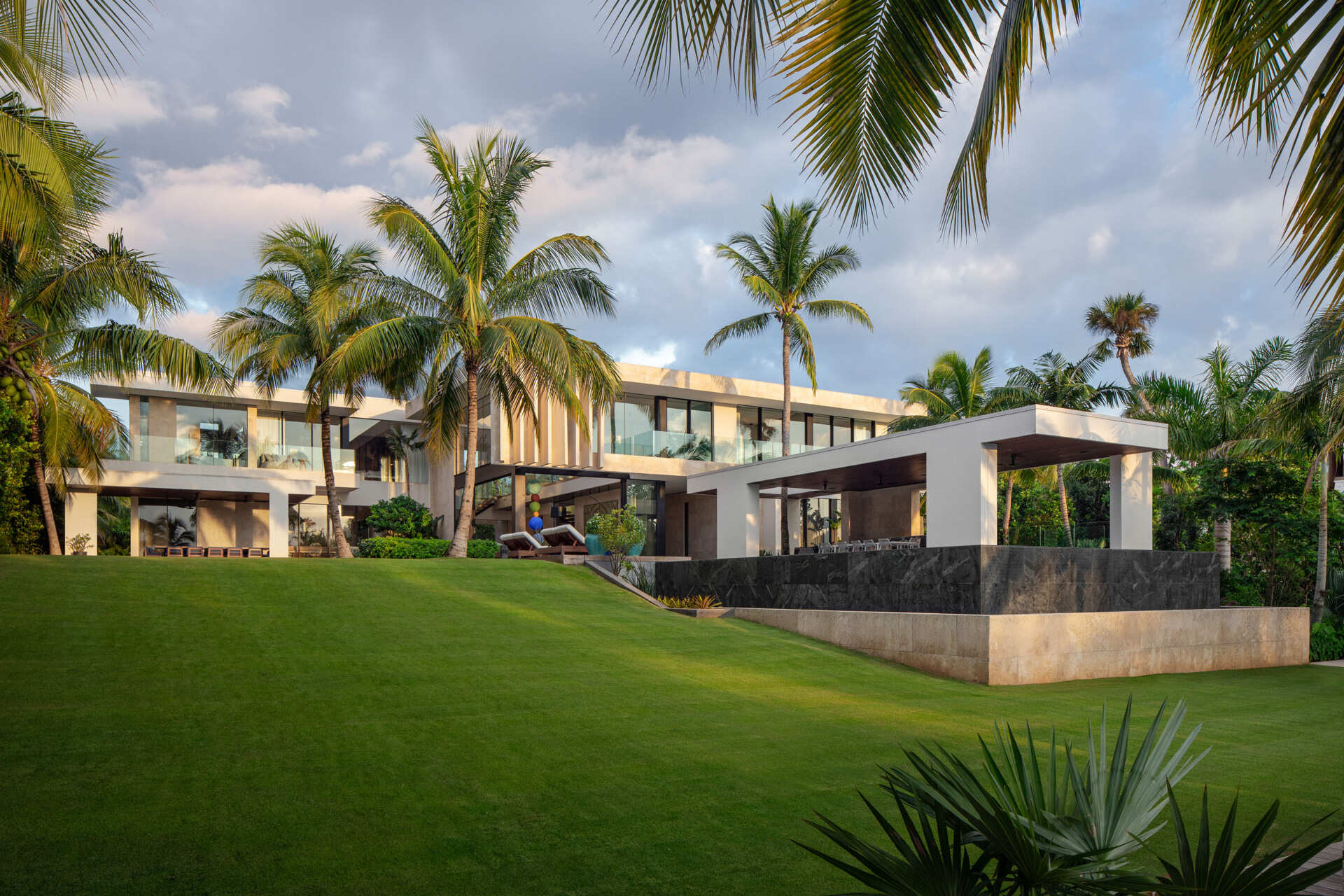 A tropical home with outdoor rooms and an infinity pool that blends naturally with the canal and surrounding greenery.